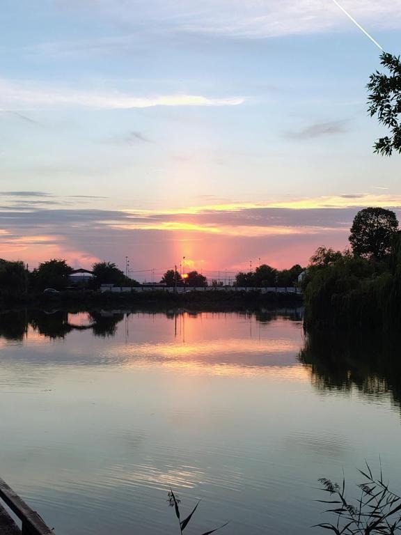 a sunset over a body of water at CASA Don Lucio in Craiova