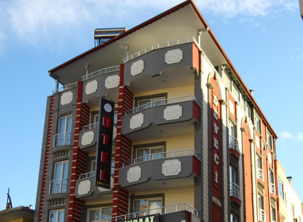 a building with clocks on the side of it at Deveci Hotel in Mut