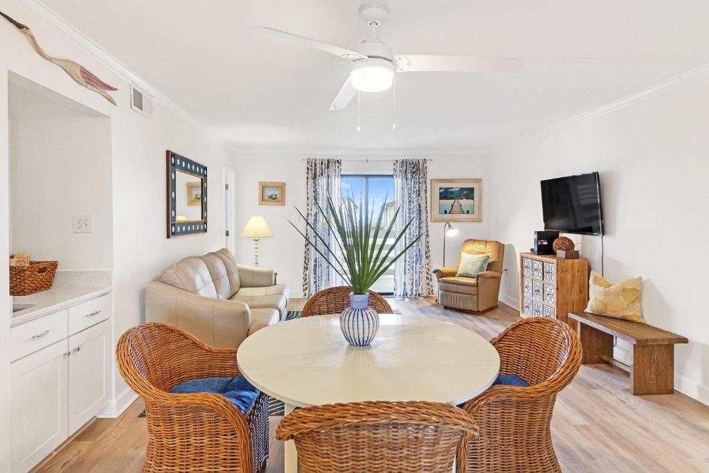 a living room with a table and chairs at 33C Lighthouse Point in Tybee Island