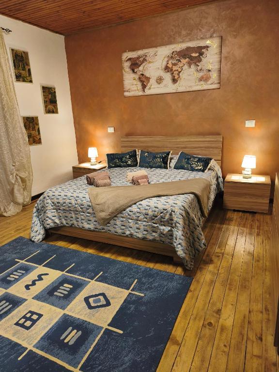 a bedroom with a bed and a blue rug at Nel blu dipinto di blu in Malesco