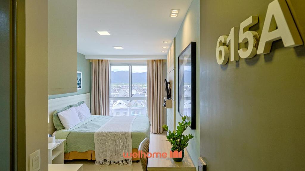 a hotel room with a bed and a window at Option Full Service Residence in Rio de Janeiro