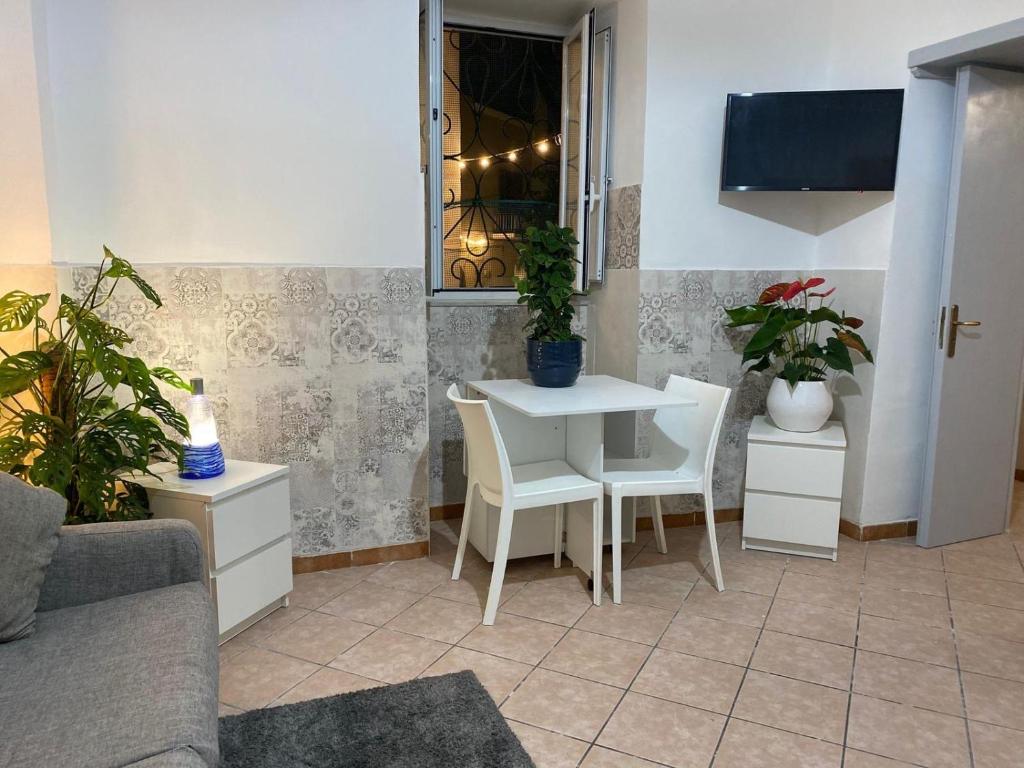 a living room with a table and chairs and plants at Morgera N8 in Forio d'Ischia