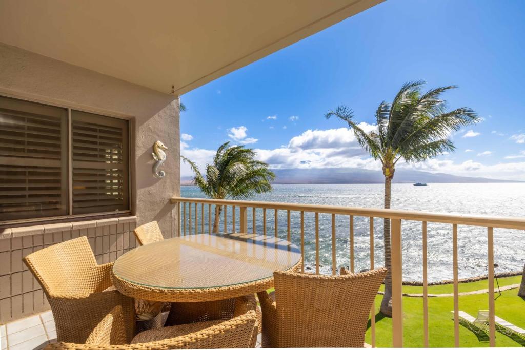 un balcon avec une table et des chaises et l'océan dans l'établissement Maalaea Kai Resort 317, à Wailuku