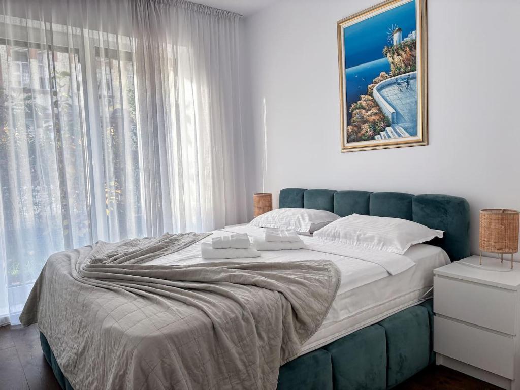 a bedroom with a large bed and a window at Sunshine Luxury Apartment Private Parking in Cluj-Napoca