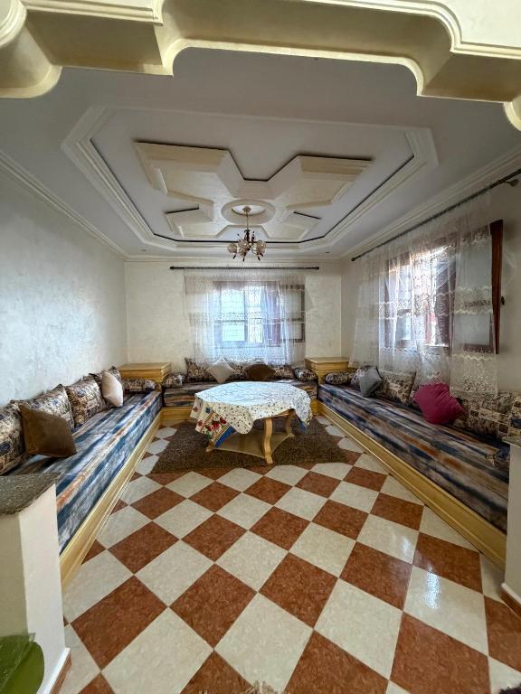 a living room with couches and a checkered floor at Samadis Home in Larache