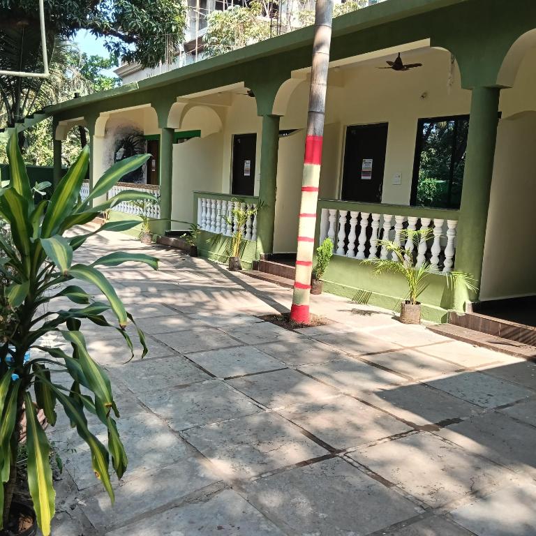 a house with a red and white pole in front of it at One love guest house morjim in Arambol