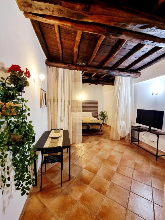 a living room with a table and a television at La Magia del Borgo in Genzano di Roma
