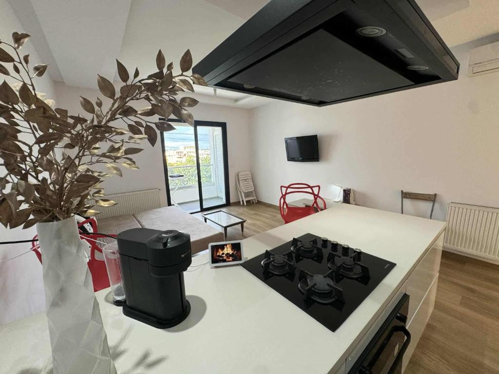 a kitchen with a stove and a counter top at New Sweet Home Soukra in Sukrah