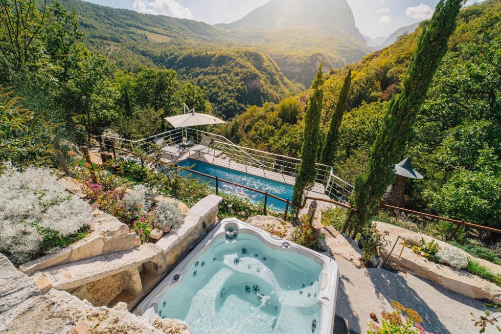an outdoor bath tub with a view of a mountain at Medieval Tower In Sibillini Mountains Park in Vetice