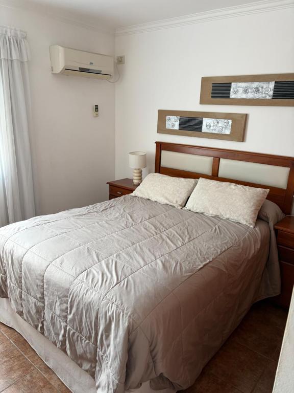 a bedroom with a bed and two tables and a window at Fenix 2 in Colón