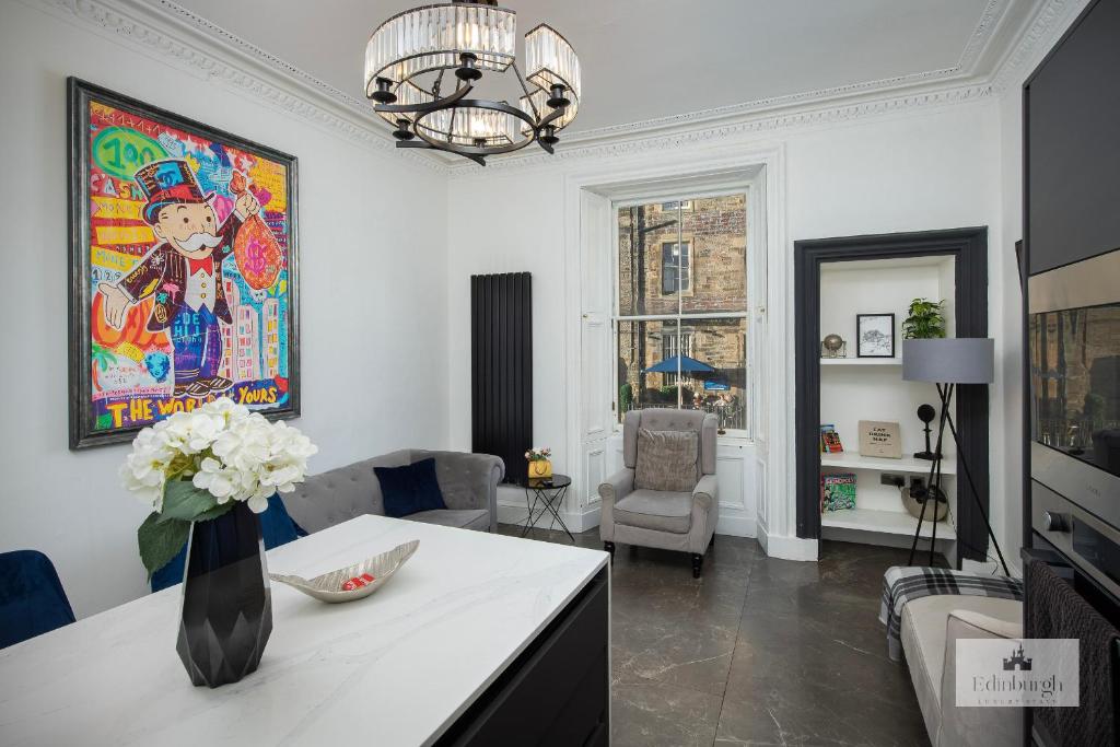 a living room with a vase of flowers on a counter at 2Bedroom apartment by the castle in Edinburgh