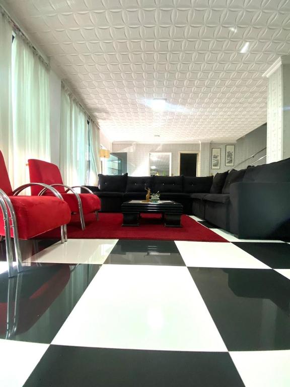 a living room with a couch and red chairs at Full Encarnacion House in Encarnación