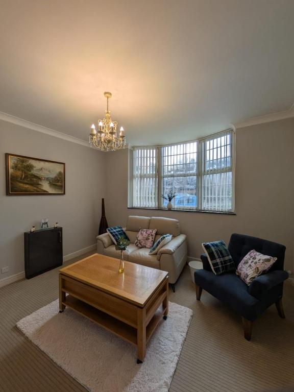 a living room with a couch and a coffee table at Bright Comfortable 1 Bedroom Flat in Neepsend
