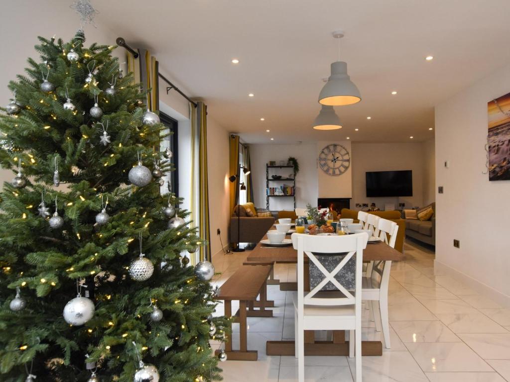 a christmas tree in the living room of a house at 4 Bed in Bude 89355 in Poughill