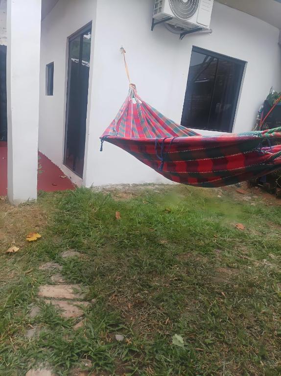 a hammock in a yard next to a building at Miraflores 1- The greenhouse in Asunción