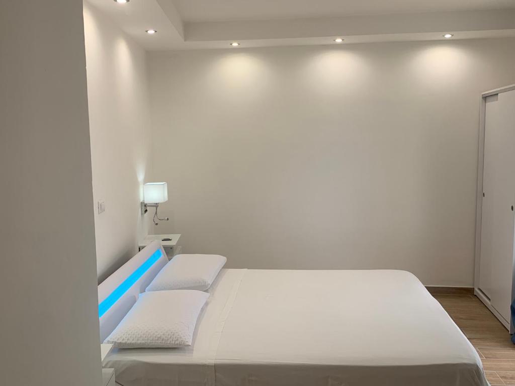 a white room with a bed and two chairs at Panoramic View in Terracina