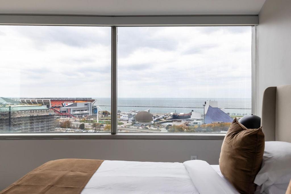 a bedroom with a large window looking out at an airport at Luxury Downtown - King Bed- Lake Views in Cleveland