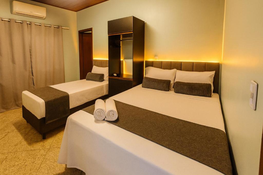 En eller flere senge i et værelse på Smart Studios 102 com ar wifi e garagem prox ao Shopping