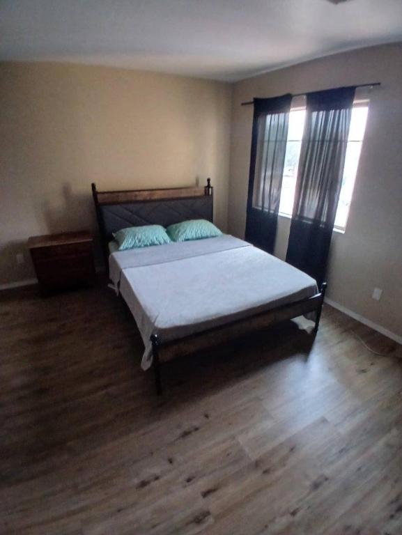 a bedroom with a bed and a wooden floor at West Phoenix Value Room 4 Bennet in Phoenix