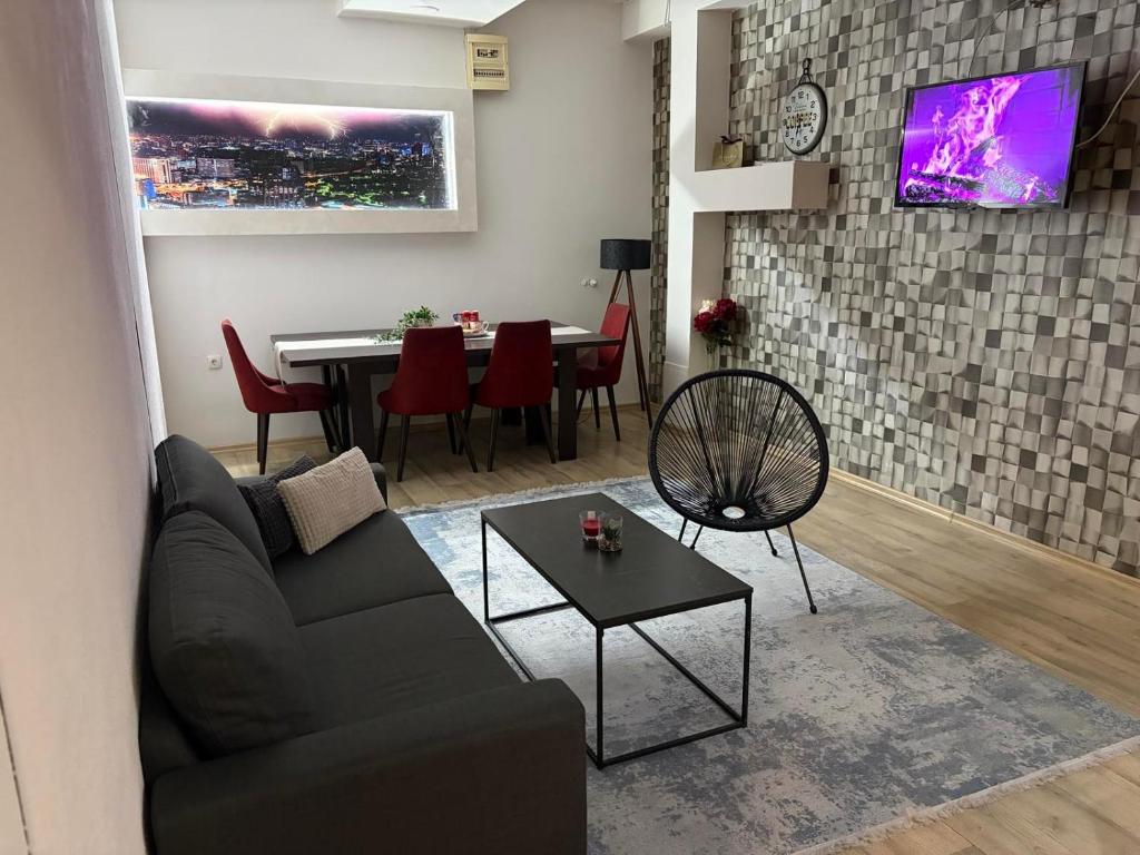 a living room with a couch and a table at Apartman Aleksandar 