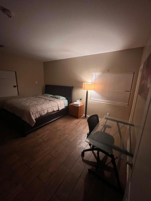 a bedroom with a bed and a desk and a chair at West Valley King Room 94th in Phoenix