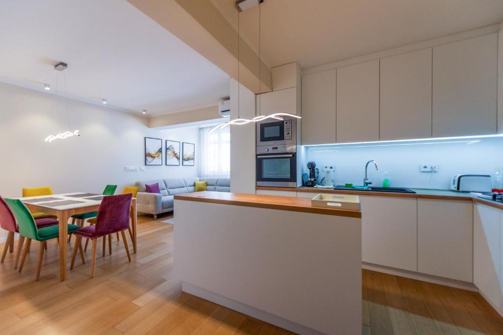 a kitchen and living room with a table and chairs at Sanja & Mirza Apartments - Old Town Sarajevo in Sarajevo