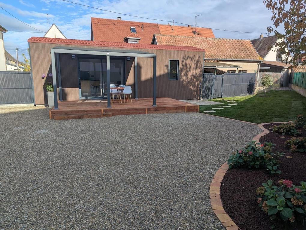a house with a deck and a patio at Gîte l'Hortensia Rose in Guémar