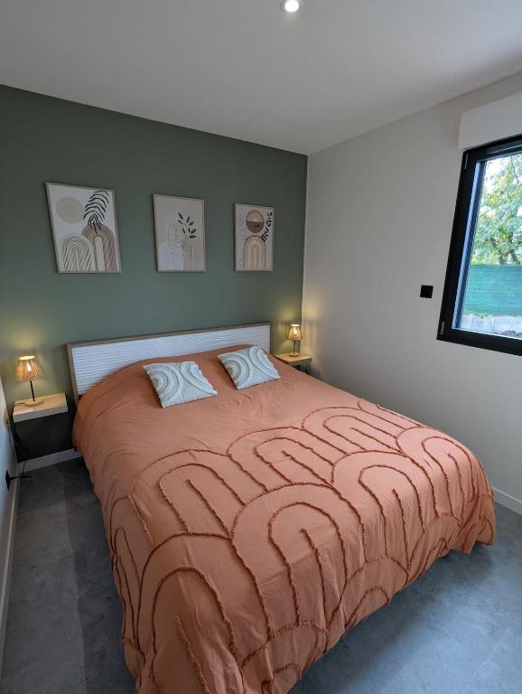 a bedroom with a large bed and a window at Gîte l'Hortensia Rose in Guémar