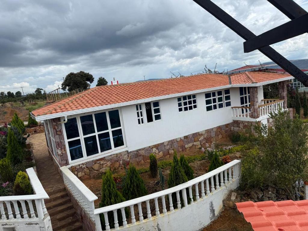 a white house with a red roof at Casa Cañón ecolodge in Los Santos