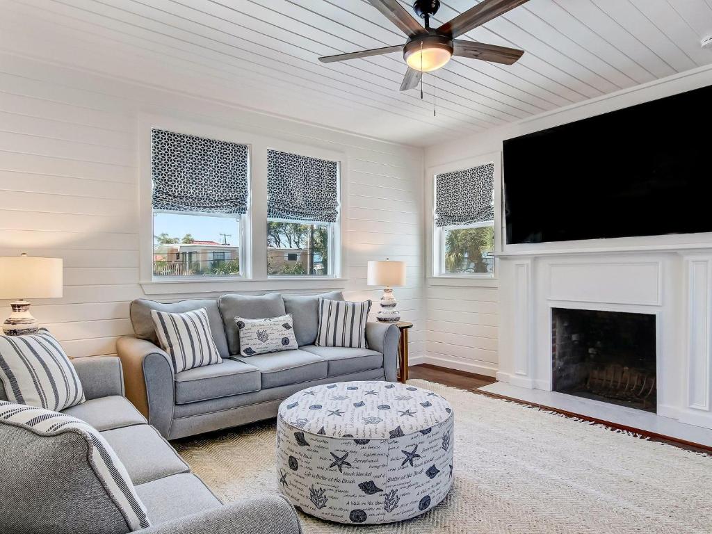 a living room with a tv and a fireplace at Beachside Villa Unit 5 in Tybee Island