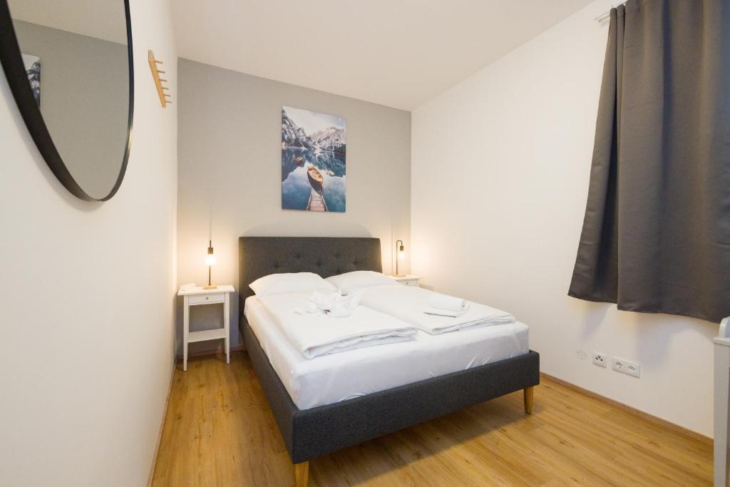 En eller flere senge i et værelse på Cosy Penzing