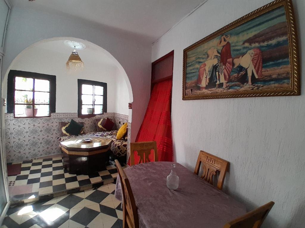 a living room with a table and a couch at Arch Guesthouse - Dorm for Budget Travelers in Tangier in Tangier