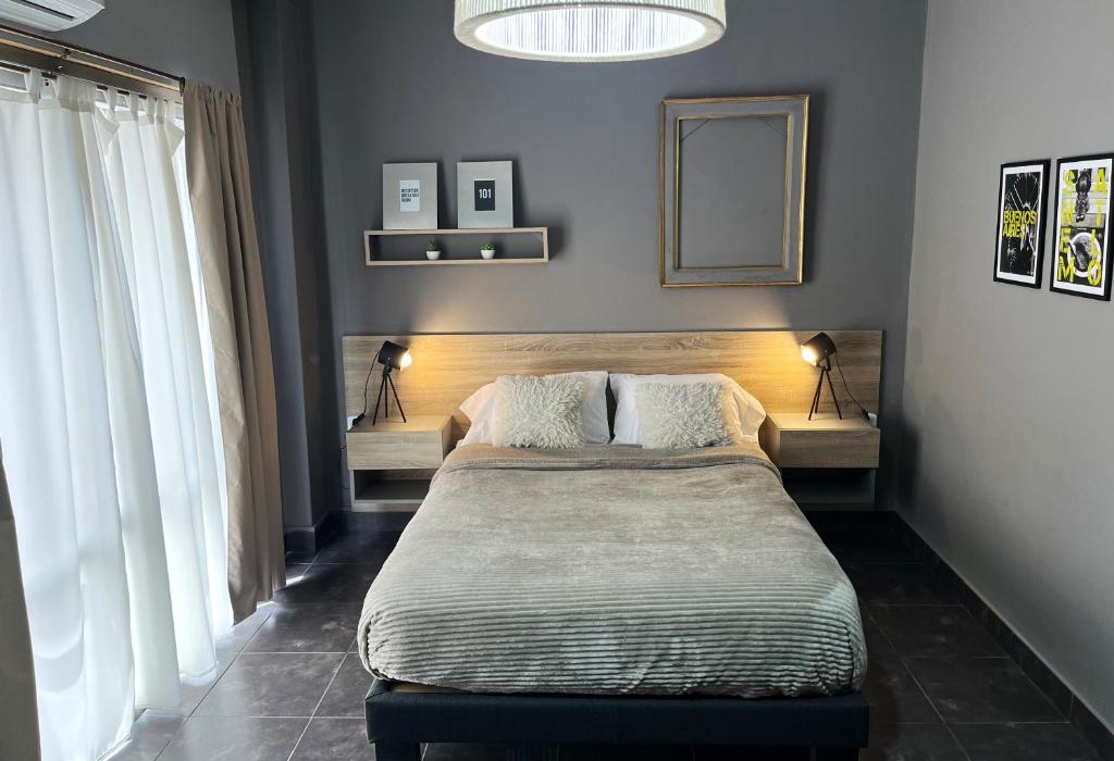 a bedroom with a bed and a mirror on the wall at Defensa 821 - Studios in San Telmo in Buenos Aires