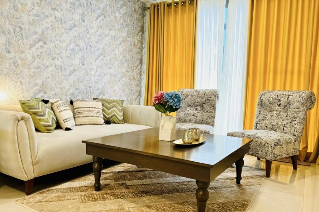 a living room with a couch and a coffee table at The look in Dehiwala