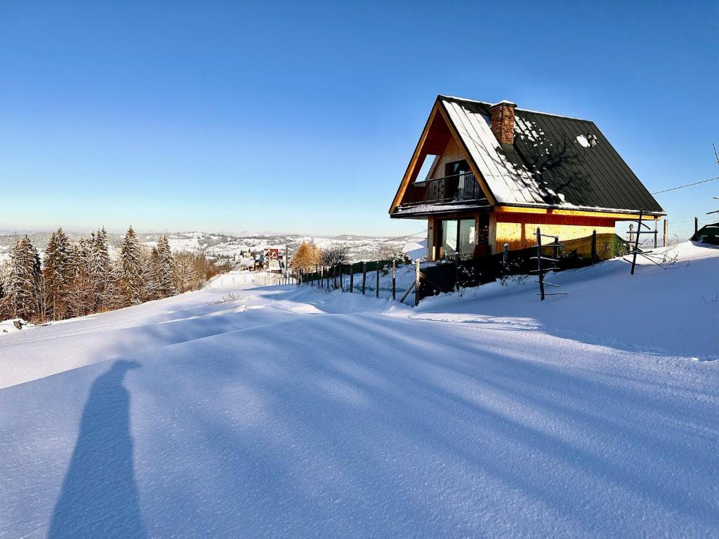 una casa situada en una carretera cubierta de nieve en Domek Tatry - Stacja Wierchowa 972 m, en Brzegi