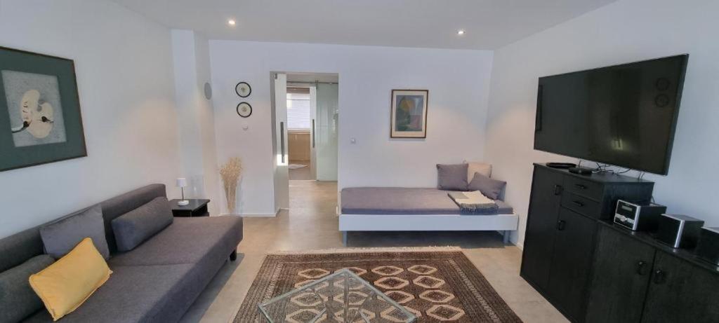 a living room with a couch and a flat screen tv at Ferienwohnung Lösel in Freilassing