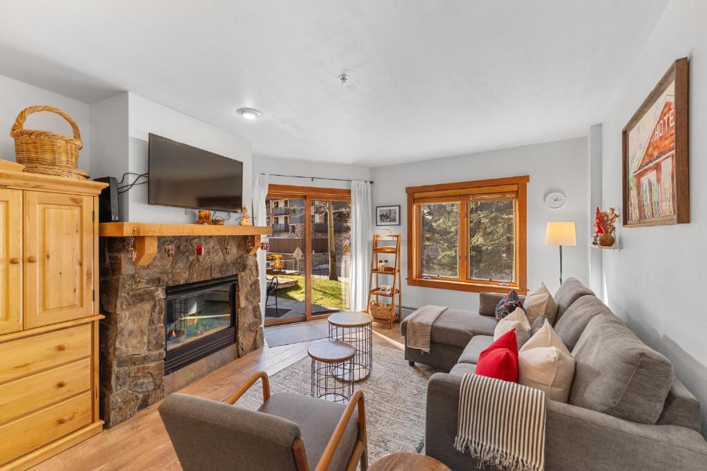 a living room with a couch and a fireplace at Red Hawk Lodge #2213 in Keystone