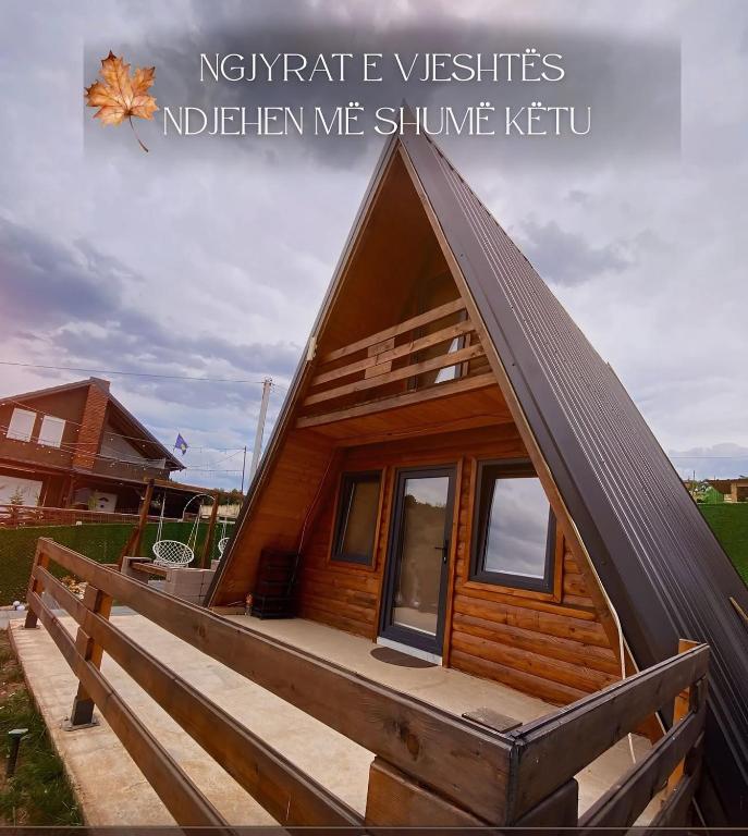 a small wooden cabin with a gambrel roof at Villa Konezal in Ferizaj