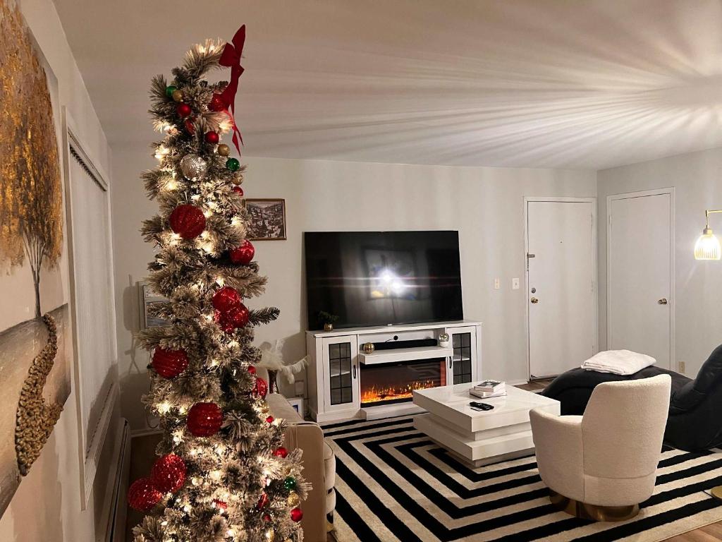 - un salon avec un arbre de Noël dans l'établissement Modern 1BR Porchlight retreat, à Farmington Hills