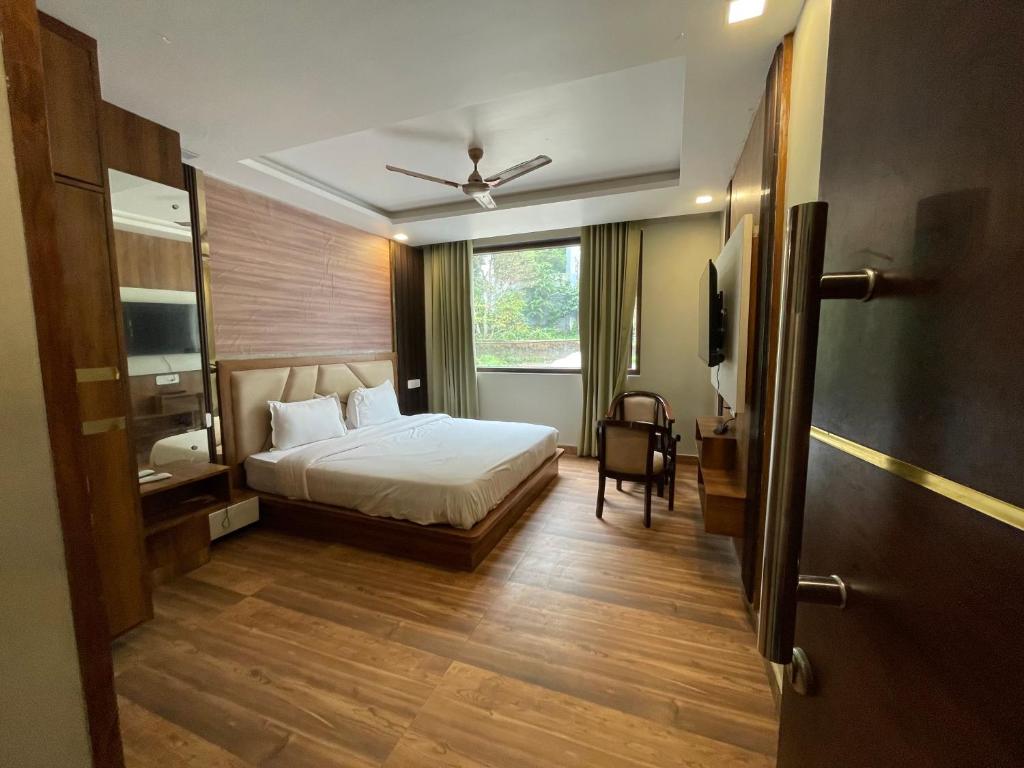a hotel room with a bed and a window at Yatram in Rishīkesh