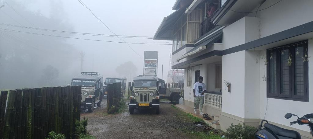 a group of trucks parked next to a building at Love shore holidays vagamon 455 chottupara in Vagamon