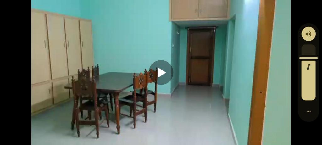 a dining room with a table and chairs at RKGroupStays in Tirupati