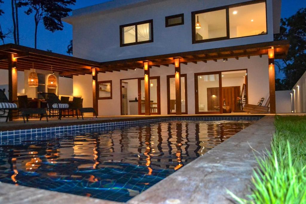 a house with a swimming pool in front of it at Casa Marah - Trancoso in Trancoso