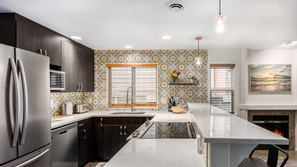 a kitchen with wooden cabinets and a refrigerator at Greenlake urban lodge in Seattle