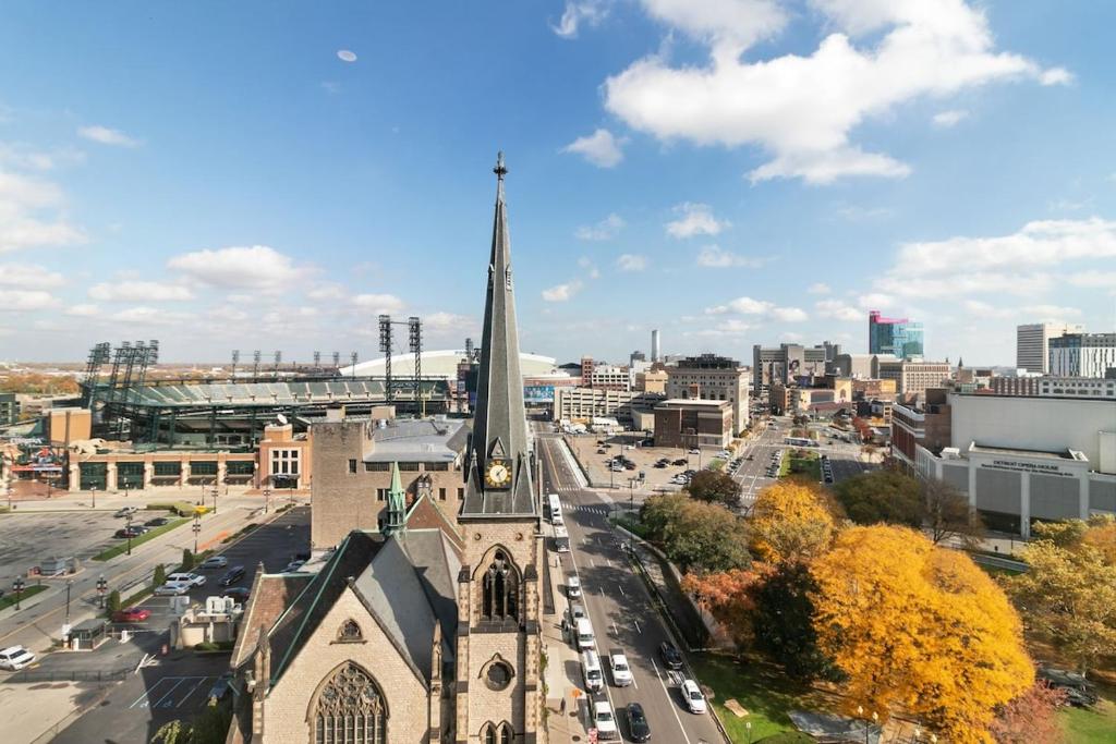 a church with a tall steeple in a city at The Nest At Twelve in Detroit