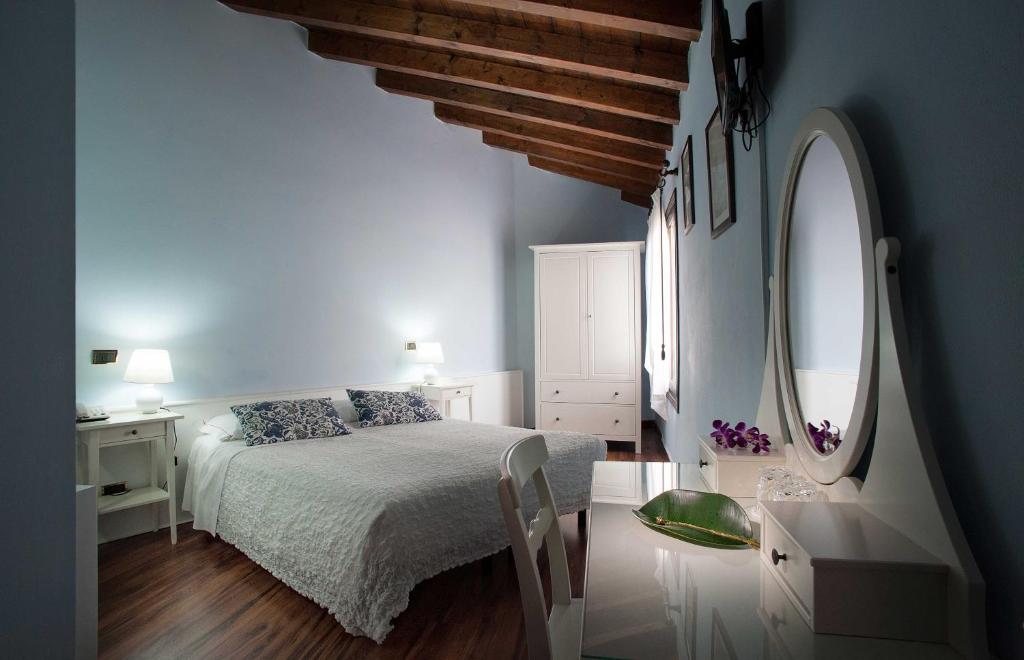Postel nebo postele na pokoji v ubytování Hotel Al Castello