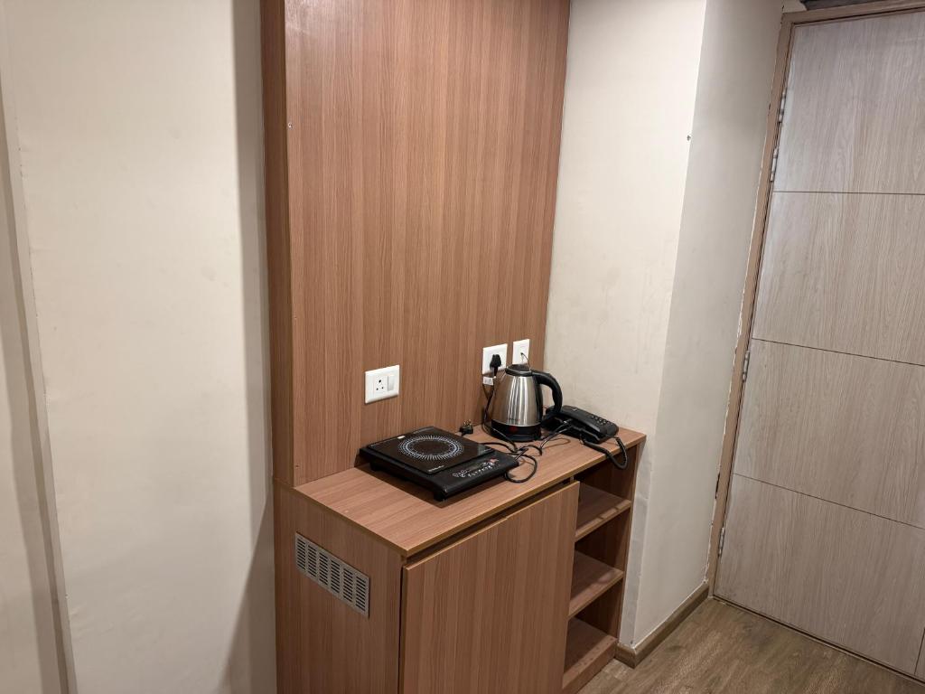 a telephone sitting on a desk in a room at Omaxe stay in Greater Noida