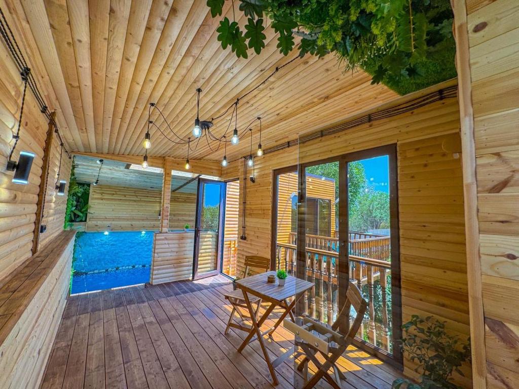 a wooden porch with a table and chairs on a deck at ErGarden in Byureghavan
