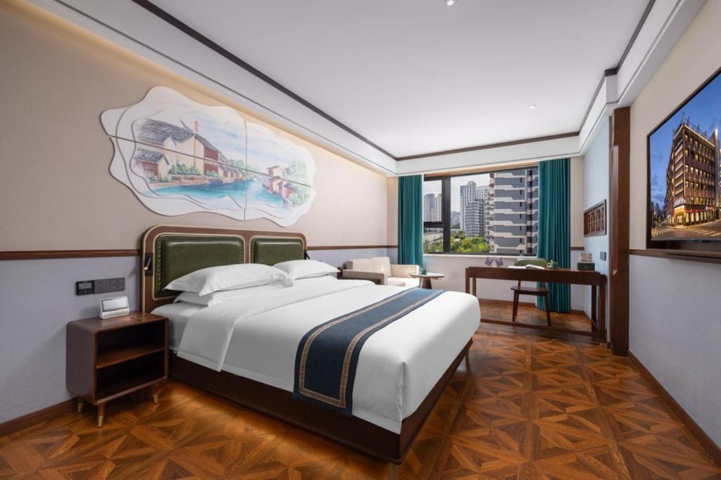 a bedroom with a bed and a painting on the wall at Nostalgia S Hotel Shanghai Railway Station & Suzhou Creek 时光漫步S酒店上海火车站苏州河店 Free fresh ground coffee,Free laundry service in Shanghai