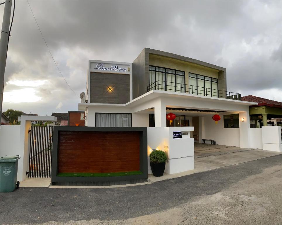 a large white house with a gate in front of it at Leisure29 Suites in Kuantan